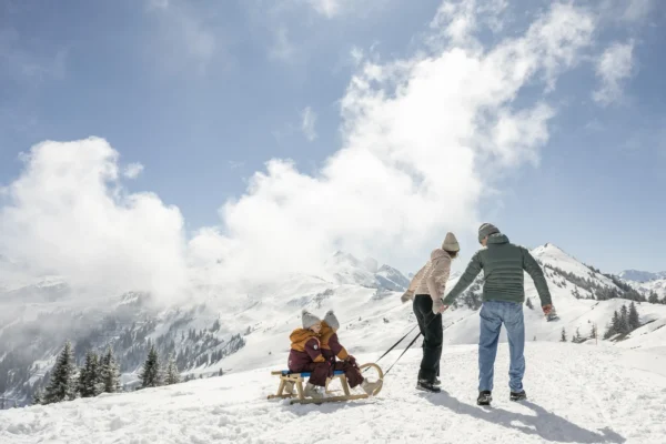 Large family drags sleds and proudly pulls the chalet